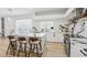 Sleek, modern kitchen with white cabinets, stainless steel appliances, and a center island with barstool seating at 1802 Regal Mist Loop, Trinity, FL 34655