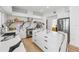 White kitchen features a large center island, stainless steel appliances, and sleek modern finishes at 1802 Regal Mist Loop, Trinity, FL 34655