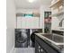 Functional laundry room with modern washer and dryer and ample storage space at 1802 Regal Mist Loop, Trinity, FL 34655