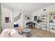 Bright living room featuring a piano, modern shelving, and stylish furnishings at 1802 Regal Mist Loop, Trinity, FL 34655
