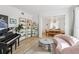 Bright living room showcasing natural light, a piano, and access to the dining room at 1802 Regal Mist Loop, Trinity, FL 34655