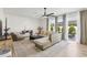 Bright living room with modern decor, a ceiling fan, and sliding glass doors to the patio at 1802 Regal Mist Loop, Trinity, FL 34655
