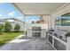 This outdoor kitchen boasts stainless steel appliances, countertop space and sink at 1802 Regal Mist Loop, Trinity, FL 34655