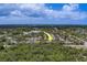 Aerial view of neighborhood with arrow showing the location of a house near the lake at 1830 Springwood N Cir, Clearwater, FL 33763