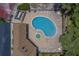 Aerial view of the community pool and jacuzzi surrounded by lounge chairs at 1830 Springwood N Cir, Clearwater, FL 33763