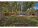 A private fenced backyard provides ample space for outdoor activities, with a view of mature trees at 1830 Springwood N Cir, Clearwater, FL 33763
