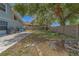 A fenced backyard with a travertine patio offers ample space for outdoor entertaining and leisure at 1830 Springwood N Cir, Clearwater, FL 33763