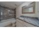 Modern bathroom with shower-tub combination and granite vanity at 1830 Springwood N Cir, Clearwater, FL 33763