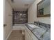 Modern bathroom with a shower-tub combination and granite vanity at 1830 Springwood N Cir, Clearwater, FL 33763