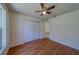 Bedroom featuring a closet, ceiling fan, and wood laminate flooring at 1830 Springwood N Cir, Clearwater, FL 33763