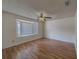 Bright bedroom with laminate flooring, ceiling fan, and a large bay window at 1830 Springwood N Cir, Clearwater, FL 33763