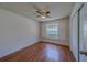 Bedroom with a ceiling fan, window with shutters, wood laminate flooring, and closet at 1830 Springwood N Cir, Clearwater, FL 33763