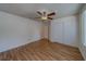 Well-lit bedroom featuring a ceiling fan, closet, and laminate wood flooring at 1830 Springwood N Cir, Clearwater, FL 33763