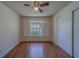 Bedroom with a ceiling fan, wood laminate flooring, window with shutters, and closet at 1830 Springwood N Cir, Clearwater, FL 33763