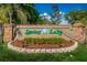 Community entrance sign for Spring Lake surrounded by greenery and a brick border at 1830 Springwood N Cir, Clearwater, FL 33763