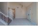 Spacious foyer with tiled floors and a stairway at 1830 Springwood N Cir, Clearwater, FL 33763