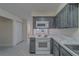 Bright kitchen features stainless steel appliances, marble countertops, and tiled flooring at 1830 Springwood N Cir, Clearwater, FL 33763