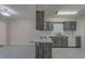 Modern kitchen featuring marble countertops, neutral toned cabinetry, and stainless steel appliances at 1830 Springwood N Cir, Clearwater, FL 33763