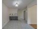 Kitchen area features marble countertops, tiled flooring, and view to living room with wood-look floors at 1830 Springwood N Cir, Clearwater, FL 33763