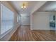 Living room with sleek flooring, plentiful natural light from large windows and a glass panel door at 1830 Springwood N Cir, Clearwater, FL 33763