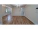 Bright living room featuring wood floors and elegant chandelier lighting at 1830 Springwood N Cir, Clearwater, FL 33763