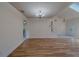Open living room space featuring a chandelier, staircase, and laminate flooring at 1830 Springwood N Cir, Clearwater, FL 33763