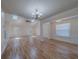 Spacious living room featuring skylight, fan, and hardwood flooring that fills the room at 1830 Springwood N Cir, Clearwater, FL 33763