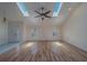 Bright living room featuring skylights, hardwood floors, and a decorative front door at 1830 Springwood N Cir, Clearwater, FL 33763