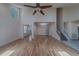 Open-concept living room featuring a high ceiling, staircase, and hardwood floors at 1830 Springwood N Cir, Clearwater, FL 33763