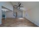 Bright and airy living room featuring high ceilings, ceiling fan, and hardwood flooring at 1830 Springwood N Cir, Clearwater, FL 33763