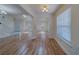 Spacious open-concept living space featuring hardwood floors and bright lighting at 1830 Springwood N Cir, Clearwater, FL 33763