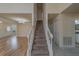 Carpeted staircase connects the living room with the upper level at 1830 Springwood N Cir, Clearwater, FL 33763