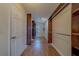 Long walk-in closet with hanging racks and laminate flooring at 1830 Springwood N Cir, Clearwater, FL 33763