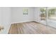 Light filled bedroom with wood floors and sliding glass door to the outdoors at 1843 Berg Rd, Holiday, FL 34690