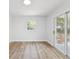 Inviting bedroom featuring wood floors, a window and sliding glass doors to the yard at 1843 Berg Rd, Holiday, FL 34690