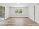 Bright bedroom features wood flooring, a window for natural light, and a sliding glass door at 1843 Berg Rd, Holiday, FL 34690