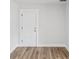 Minimalist interior door design, seamlessly blending with the room's modern aesthetic and wood-look flooring at 1843 Berg Rd, Holiday, FL 34690