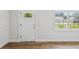 Welcoming entryway with a modern front door, complemented by stylish wood-look flooring at 1843 Berg Rd, Holiday, FL 34690