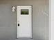 Inviting front door with a modern design and a secure lock, enhancing curb appeal at 1843 Berg Rd, Holiday, FL 34690