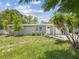 Charming single-story home with a freshly painted exterior and lush landscaping at 1843 Berg Rd, Holiday, FL 34690