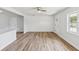 Open living space featuring modern paneling, newly installed wood-look floors, and natural light at 1843 Berg Rd, Holiday, FL 34690