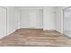 An all-white room with a door and closet boasts light, wood-look floors and ample storage at 1843 Berg Rd, Holiday, FL 34690