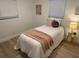 Cozy bedroom with twin bed, simple decor, and wood-look flooring at 1913 W Saint Conrad St, Tampa, FL 33607