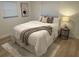 Serene bedroom featuring a queen bed, neutral tones, and warm lighting at 1913 W Saint Conrad St, Tampa, FL 33607