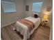 Cozy bedroom with bright light, wood-look flooring, and soothing decor at 1913 W Saint Conrad St, Tampa, FL 33607