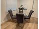 Dining area featuring a round glass table, four upholstered chairs, and bright window light at 1913 W Saint Conrad St, Tampa, FL 33607