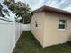 Side view of a well-maintained home with a fenced yard and manicured lawn at 1913 W Saint Conrad St, Tampa, FL 33607