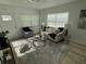 Inviting living room with wood-look flooring, neutral furniture, and lots of natural light at 1913 W Saint Conrad St, Tampa, FL 33607
