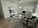 Bright living room with neutral furniture, wood-look flooring, and stylish decor at 1913 W Saint Conrad St, Tampa, FL 33607