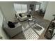 Sun-filled living room with sleek flooring, contemporary decor, and neutral-toned furnishings at 1913 W Saint Conrad St, Tampa, FL 33607